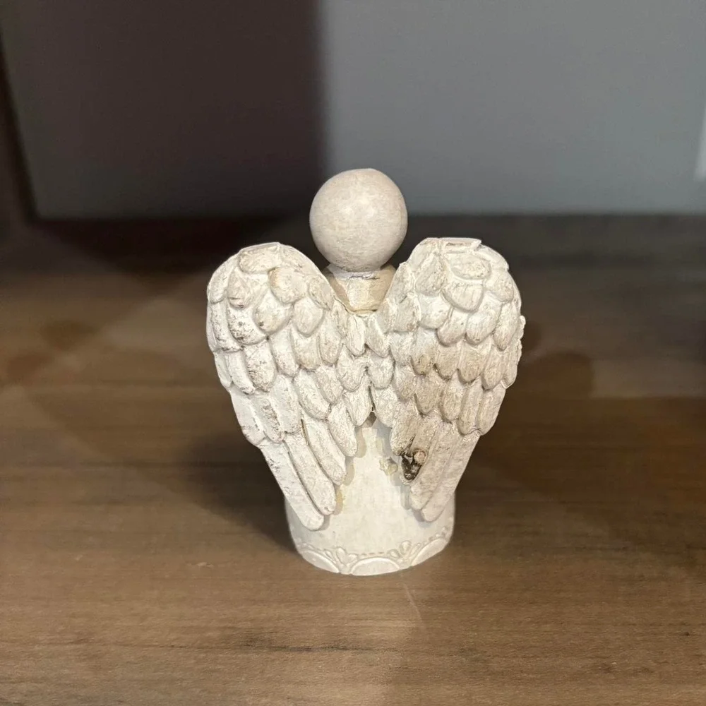 White angel figurine with silver heart